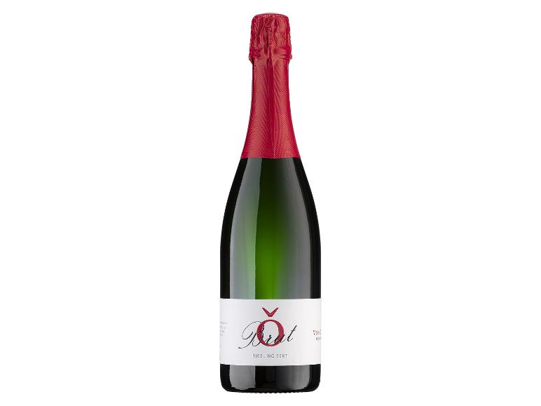 Grüne Sektflasche mit roter Kapsel und weißem Etikett mit der Aufschrift „Brut Riesling Sekt“.