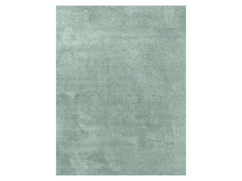 Rechteckiger mintgrüner Teppich mit weicher Textur.