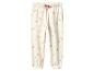 Cremefarbene Kinderjogginghose mit Blumenmuster.