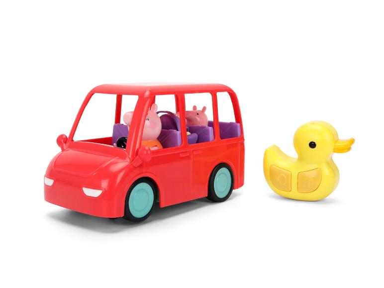 Rotes Spielzeugauto mit Figuren und gelbe Gummiente.