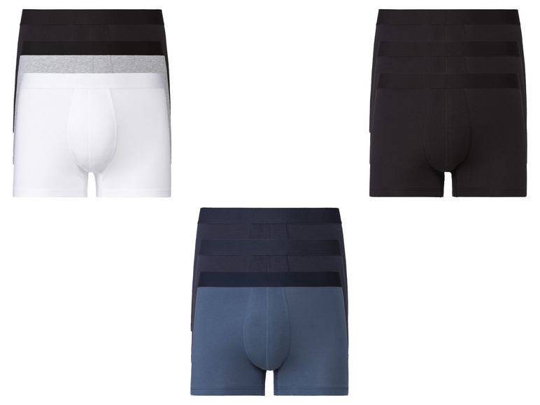 Drei Paar Boxershorts: weiß, schwarz und dunkelblau.