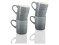 Vier graue Le Creuset Tassen gestapelt.