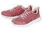 Ein Paar rosa Sportschuhe mit weißen Schnürsenkeln und weißen Sohlen.