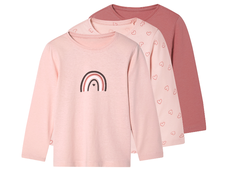 Drei langärmelige Shirts für Mädchen in Rosatönen mit Regenbogen- und Herzmotiven.