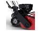 Detail einer rot-schwarzen Gartenmaschine mit Motor und Zahnrädern.