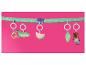 Hängende Babyspielzeuge: Krokodil, Wassermelone, Blatt und Teddybär an einer grünen gepunkteten Stange.