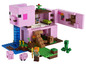 Lego Minecraft Set mit einem rosafarbenen Schweinehaus, einer Minifigur und einem Creeper.
