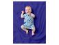 Baby in einem blauen Strand-Strampler, liegend auf einer blauen Decke.