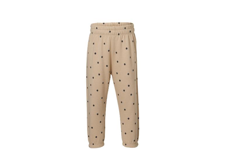 Beige Jogginghose mit schwarzen Punkten, elastischem Bund und Bündchen.