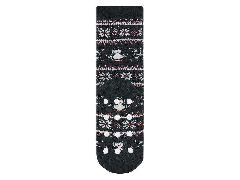 Schwarze Socken mit Pinguin-Motiv und rutschfesten Punkten.