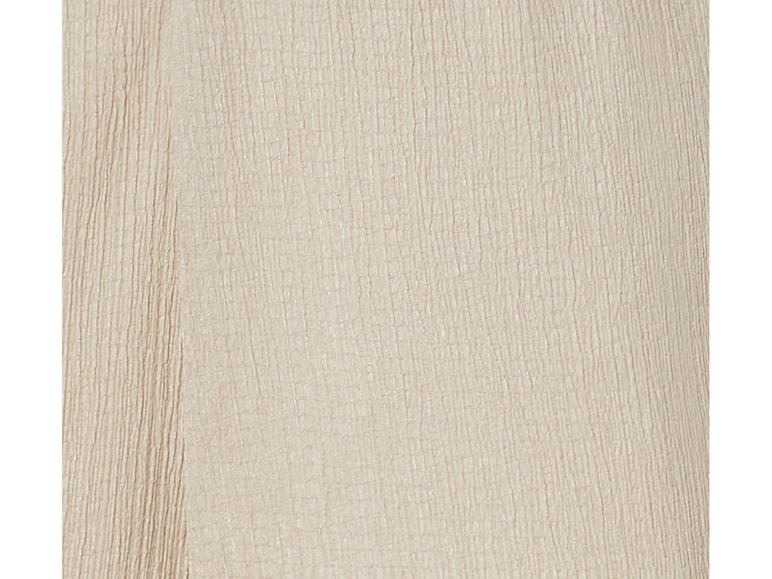 Nahaufnahme eines beigefarbenen Stoffes mit gekräuselter Textur.