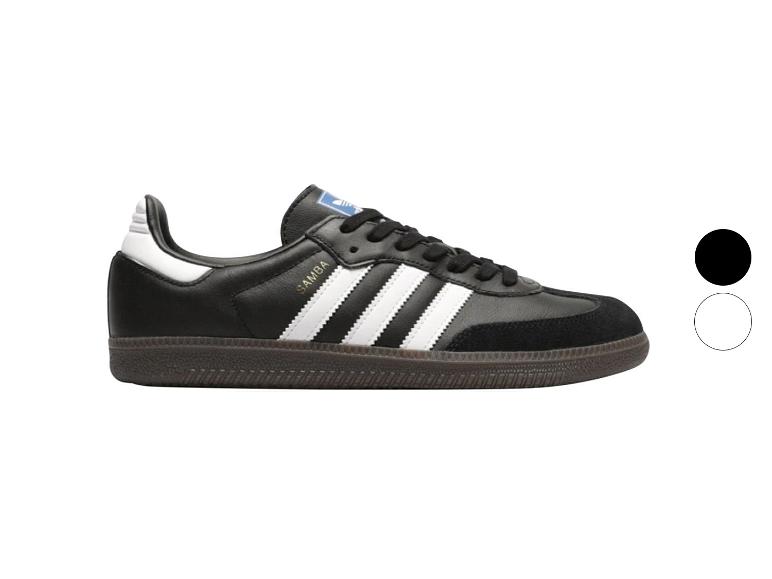 Schwarze Sportschuhe mit weißen Details und Gummisohle.