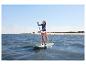 Eine Frau paddelt auf dem mintgrünen HOME DELUXE Stand Up Paddle Board Moana.