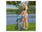 Eine Frau packt ein aufblasbares Hydro-Force SUP in eine Tasche am See.