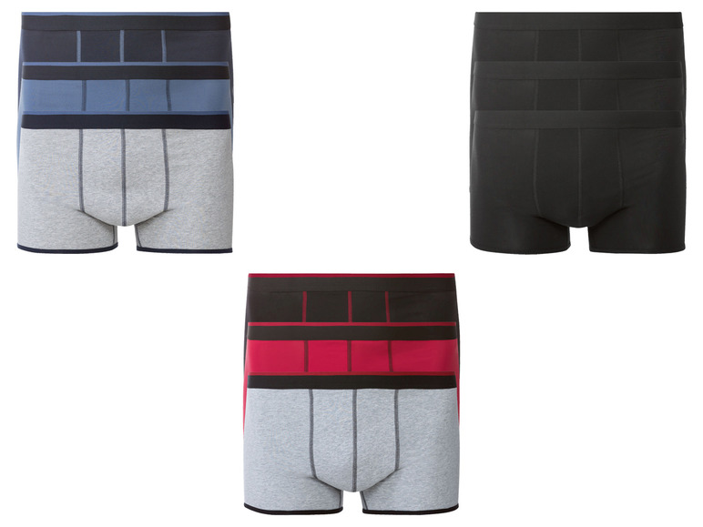 Drei Paar Herrenboxershorts: grau mit blauen, roten und schwarzen Details.