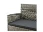 Nahaufnahme eines grauen Rattan-Gartensofas mit dunkelgrauem Kissen.