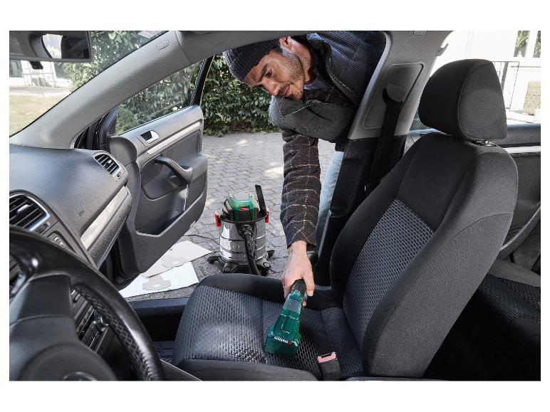 Mann reinigt Autositz mit Parkside Nass- und Trockensauger.