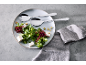 Salatbesteck auf einem Teller mit frischem Salat, Feta und Croutons.