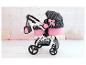 Ein rosa Kinderwagen mit Herzchenmuster, inklusive Tasche