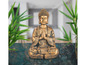 Eine goldene Buddha-Figur in Meditationshaltung.