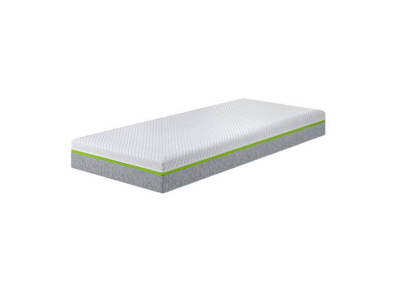 Eine weiße Matratze mit grauen Seiten und grünem Rand.