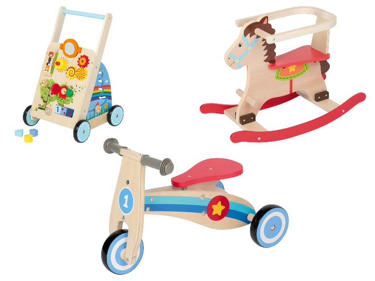 Ein Lauflernwagen aus Holz, Schaukelpferd und Laufrad.