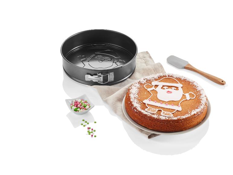 Eine Weihnachtskuchen mit einem Santa Claus Design, eine Springform und Dekoration.