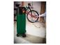 Luftkompressor füllt einen Fahrradreifen, mit einem Fahrrad im Hintergrund.