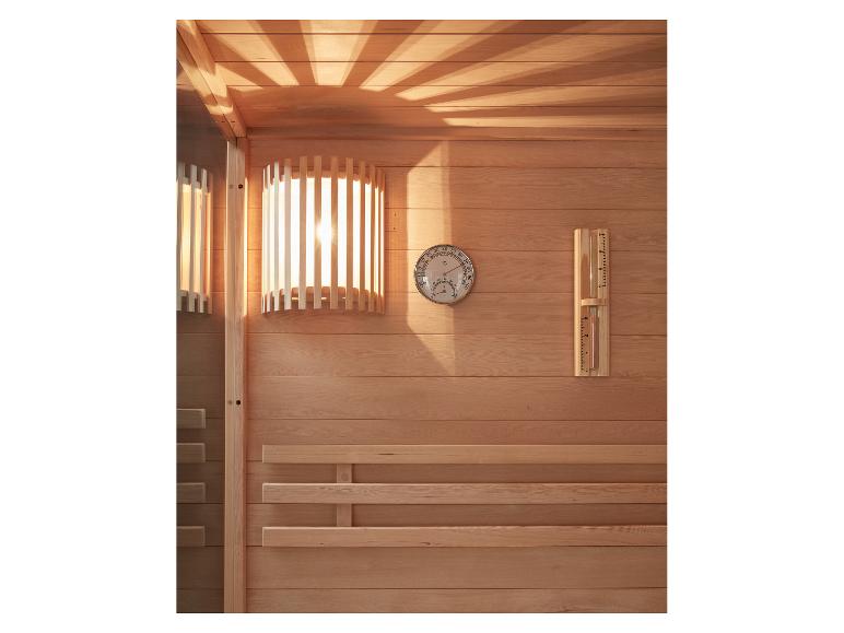 Holzsauna mit Thermometer, Hygrometer und stimmungsvoller Beleuchtung.