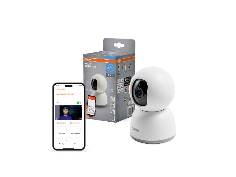 Smarte 360-Grad-Kamera und ihre Verpackung, daneben ein Telefon mit Kamera-App.