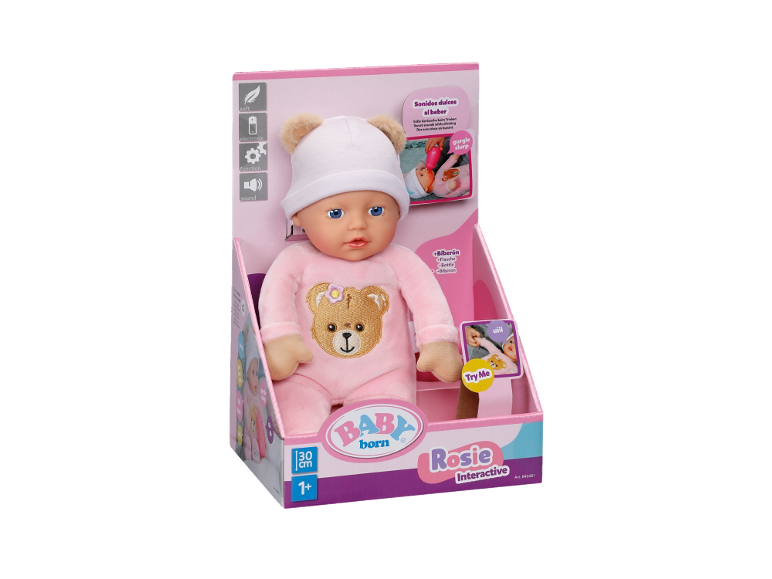 Interaktive Babypuppe im rosa Strampler und Mütze in der Verpackung.