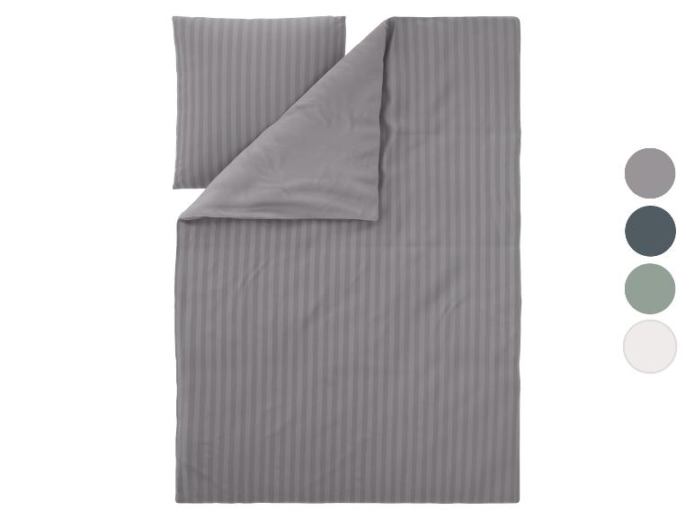 Graues Bettwäsche-Set mit Streifen und Farbmustern.