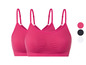 Zwei rosa nahtlose Sport-BHs mit Spaghettiträgern.