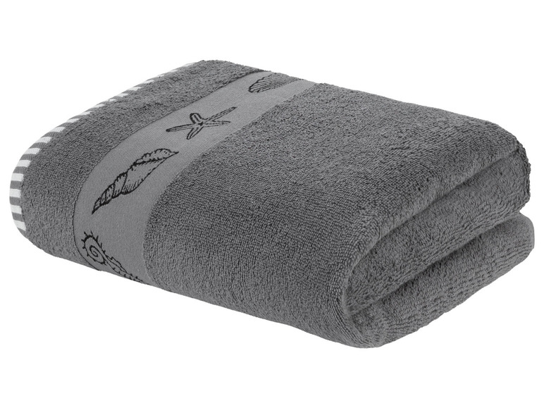 Ein graues Handtuch mit Muschelmotiven