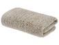Gefaltetes beiges Handtuch mit gerippter Textur