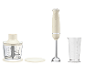Cremefarbener Stabmixer mit Zerkleinerer und Messbecher im Retro-Stil.