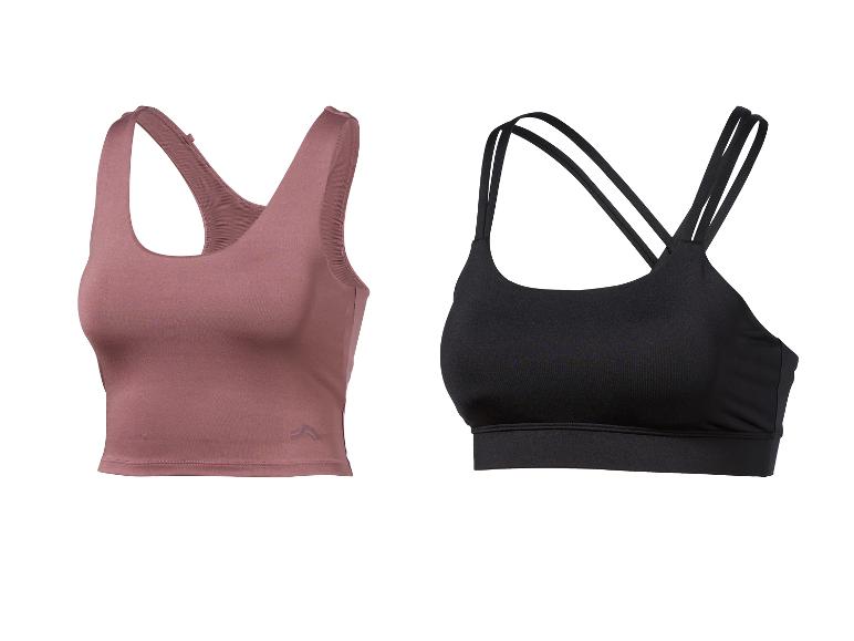 Zwei Sport-BHs, einer rosa-braun und einer schwarz, auf weißem Hintergrund.