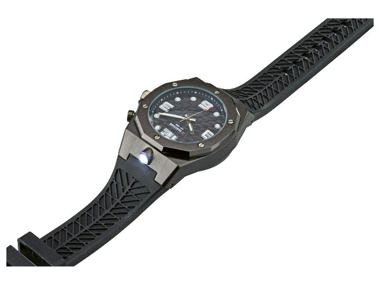 Eine schwarze Armbanduhr mit strukturiertem Armband und einer kleinen Taschenlampe an der Seite.