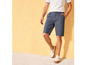 Mann in blauen Shorts und weißen Schuhen