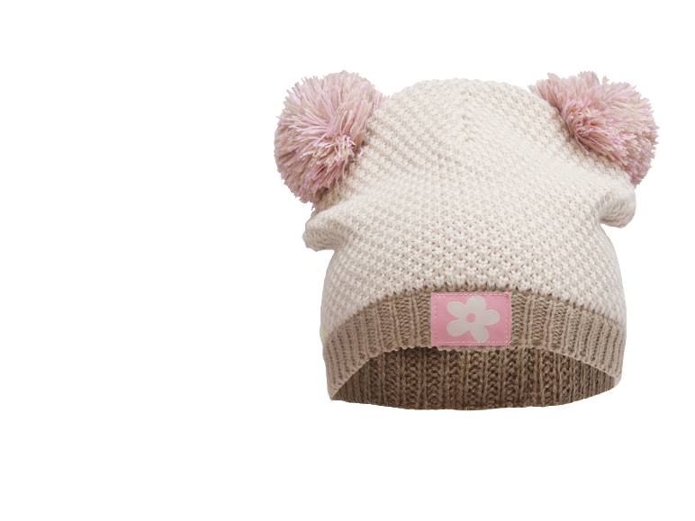 Gestrickte Kindermütze mit zwei rosa Bommeln und einem rosa Blumenemblem.