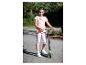 Lächelndes Mädchen in rosa T-Shirt und Leggings, hält einen grünen und schwarzen Roller.