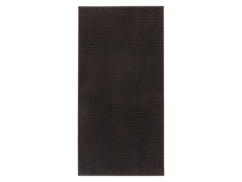 Dunkelgraue Badematte mit gerippter Oberfläche.