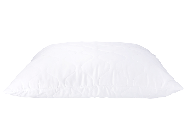 Ein weißes, gestepptes Kissen.