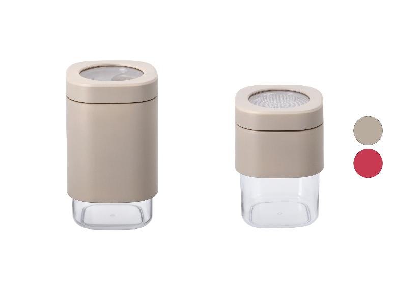 Zwei quadratische Vorratsbehälter, einer mit Siebdeckel, in Beige und Transparent.