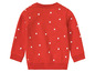 Roter Pullover mit weißen Punkten.