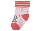 Rosa Baby-Socken mit Sternen und einer Cartoonfigur.