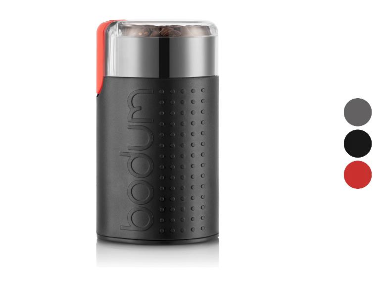 Bodum Kaffeemühle in Schwarz mit rotem Deckel und Kaffeebohnen.