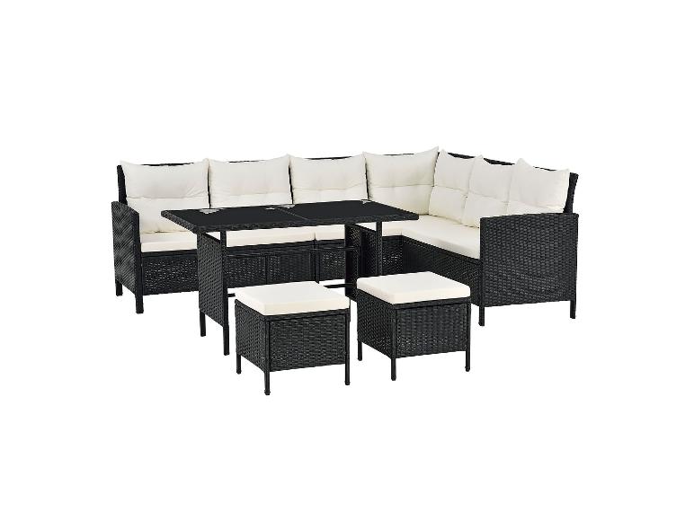Schwarze Rattan-Gartenlounge mit weißen Kissen, einem Tisch und Hockern.