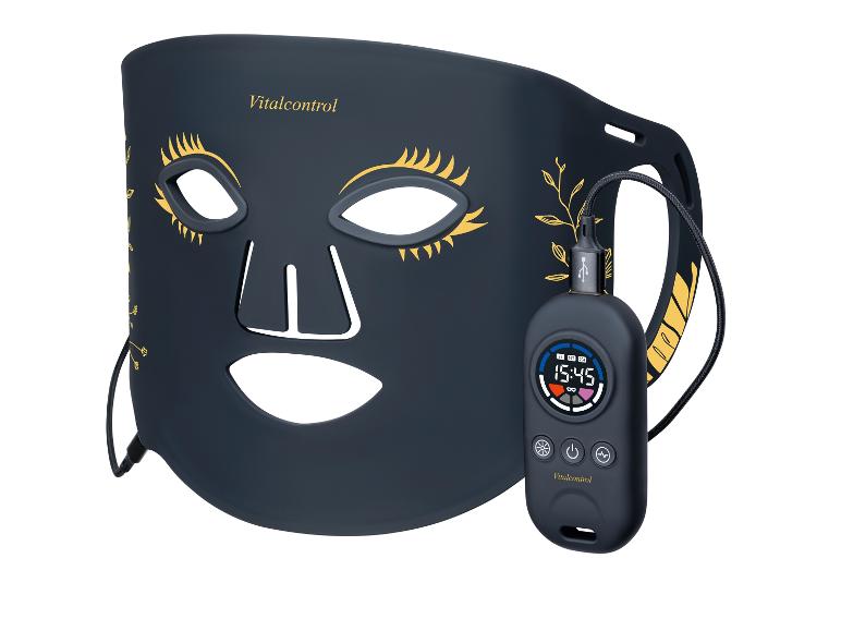 Gesichtsmaske mit Controller, mit goldenen Wimpern und Blattmotiven.