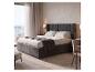 JUSKYS Polsterbett »Savona«: Graues Polsterbett mit hohem Kopfteil und Balkon mit Meerblick.